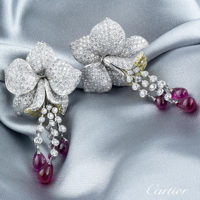 <p>Cartier Caresse D Orchidees Diamond and Ruby Platinum Earrings</p>
